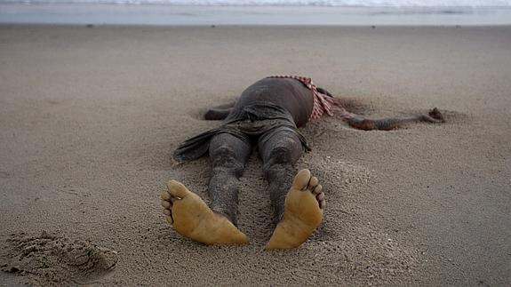 Cadáver de un inmigrante etíope arrastrado por las olas hasta la playa de Ahwar (Yemen). 