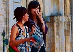 Dos turistas ojean un mapa en la plaza de La Virgen / J.J. MONZÓ