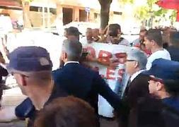 Sanz, protegido por la Policía, entre abucheos. / Intersindical RTVV
