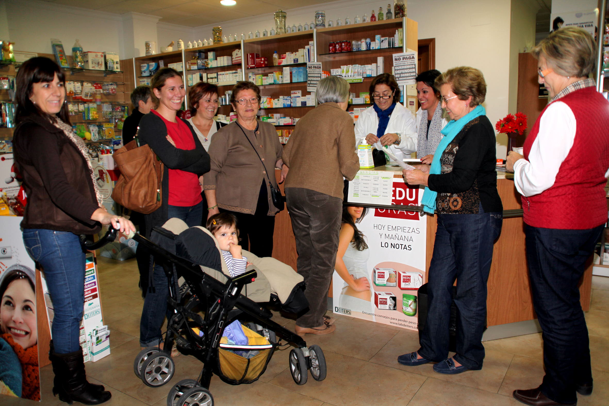 Clientes compran en una farmacia. TINO CALVO