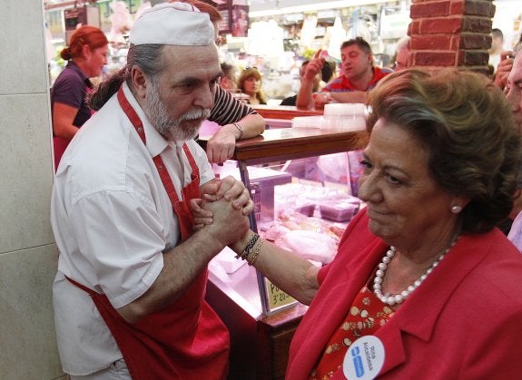 Un comerciante del mercado del Cabanyal anima a Barberá en un momento de la visita electoral.