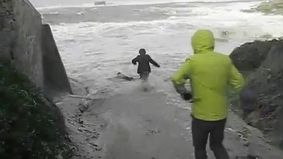 Las tres personas arastradas por las olas, en la versión corta del vídeo (1:49).