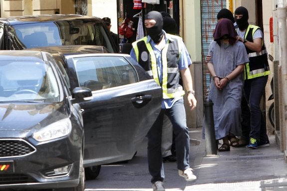 El presunto yihadista con el rostro tapado, el pasado martes, en la calle Corretgeria de Valencia. :: irene marsilla