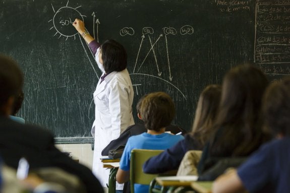 Una profesora imparte clase a sus alumnos. :: AFP