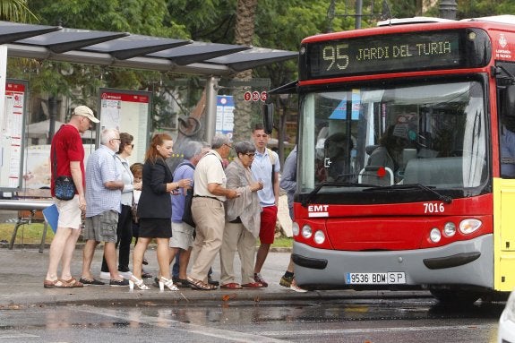 Un grupo de usuarios cogen un autobús de la línea 95 junto al río, ayer por la mañana. :: manuel molines