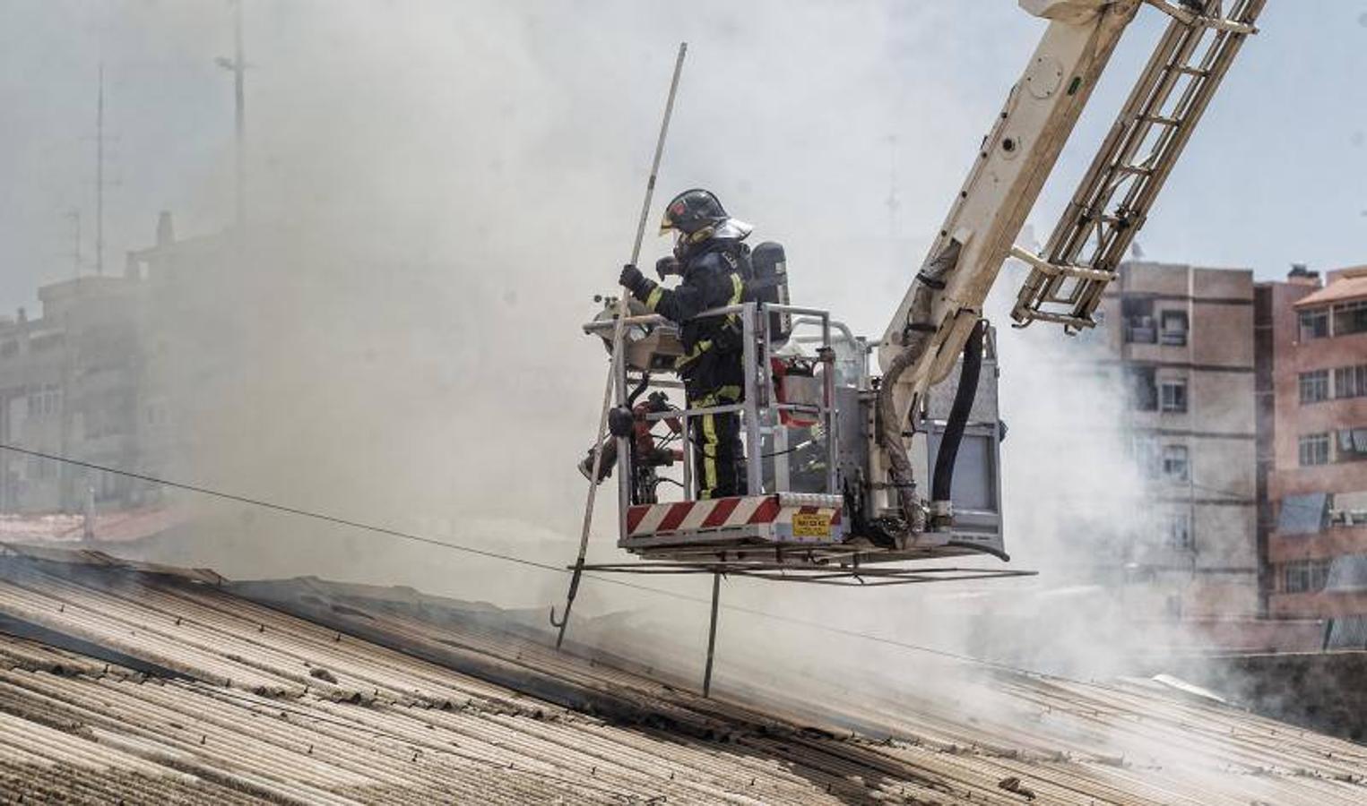 Los bomberos trabajan para extinguir un incendio en una nave abandonada