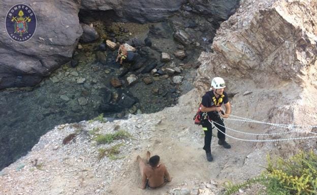 Un bombero junto a uno de los jóvenes en pleno rescate.