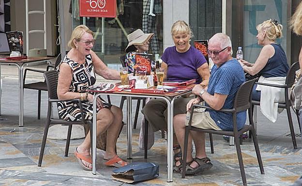 Tres turistas sentados en una terraza de Cartagena.