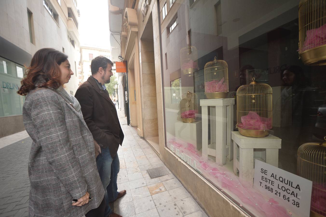 Un bodegón con muñecos dorados articulados, unas pajareras llenas de cascabeles o un montón de neumáticos decorados con plantas enredaderas son algunas de las propuestas de la arquitecta Helia San Nicolás que ha reconvertido los escaparates de siete comercios de la ciudad