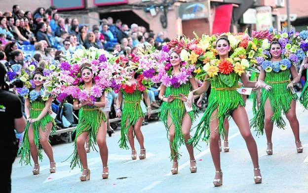 Comparsa con tocados de flores naturales y gradas abarrotadas en Cabezo de Torres.