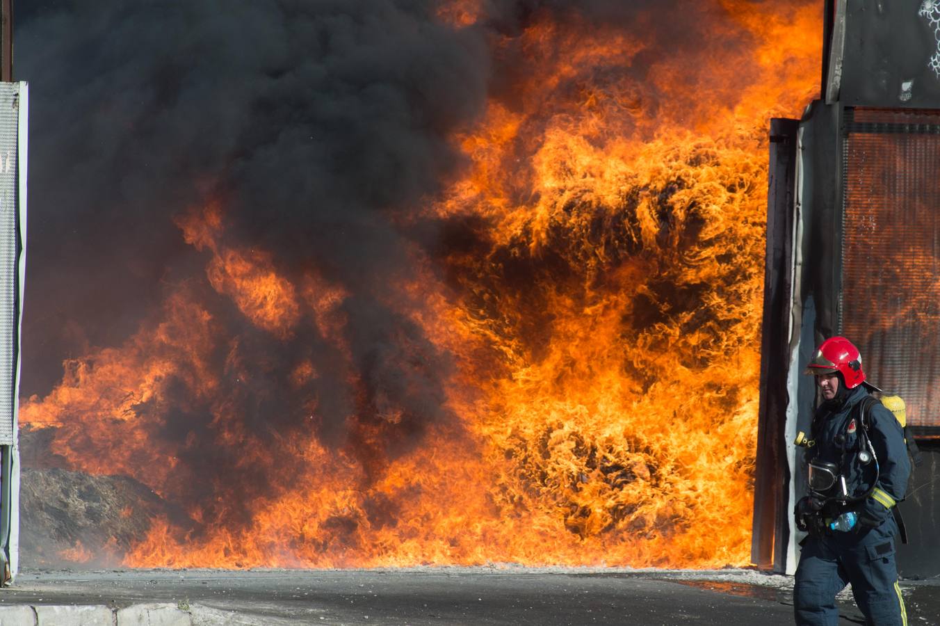 Los bomberos trabajan en la extinción de un incendio en una empresa de reciclaje de residuos en Santomera que ha originado una gran columna de humo a primera hora de la tarde, alrededor de las 16.30 horas de este miércoles.