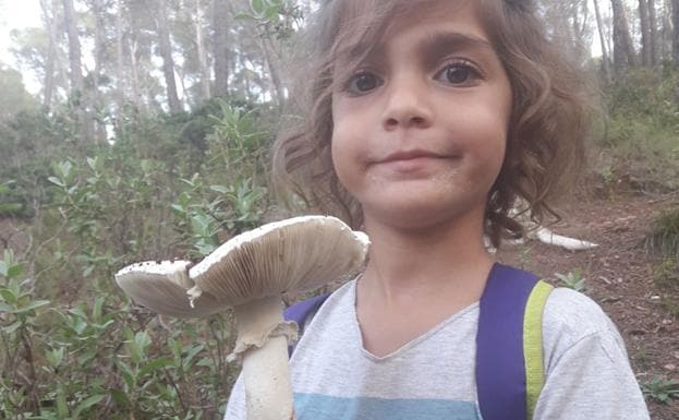 Vega, la hija de la autora de este reportaje, muestra una 'Amanita ovoidea' recolectada en el campo. 