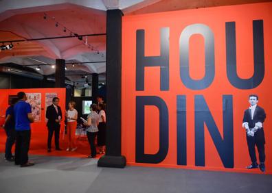 Imagen secundaria 1 - Una de las réplicas de una camisa de fuerza que utilizó el ilusionista nacido en Budapest en 1874. | Panorámica de la exposición en Murcia, donde juegan un papel fundamental los colores rojo y negro. | Houdini intentó desmontar a los creyentes en el espiritismo como el detective Sherlock Holmes, personaje creado en 1887 por el escritor escocés Arthur Conan Doyle, a quien perdió como amigo.