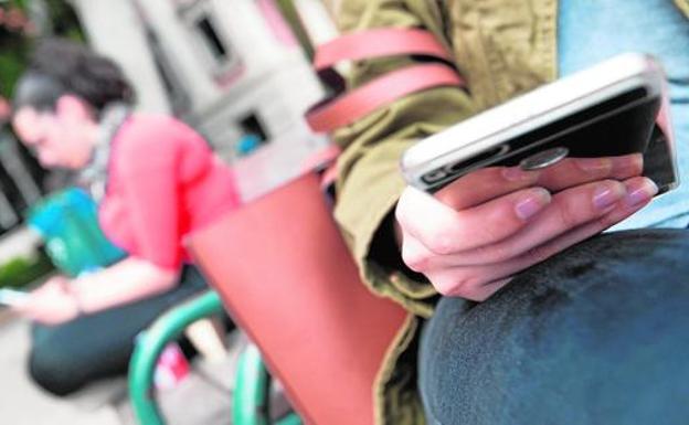 Estudiantes en el campus de La Merced, con sus teléfonos móviles. 