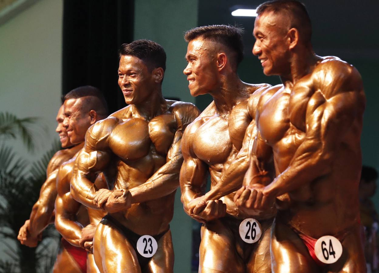 Los participantes exhiben sus bronceados y perfectamente tonificados músculos durante la 16 edición del campeonato de Culturismo y Deportes del Sudeste Asiático celebrado en Yangon (Birmania).
