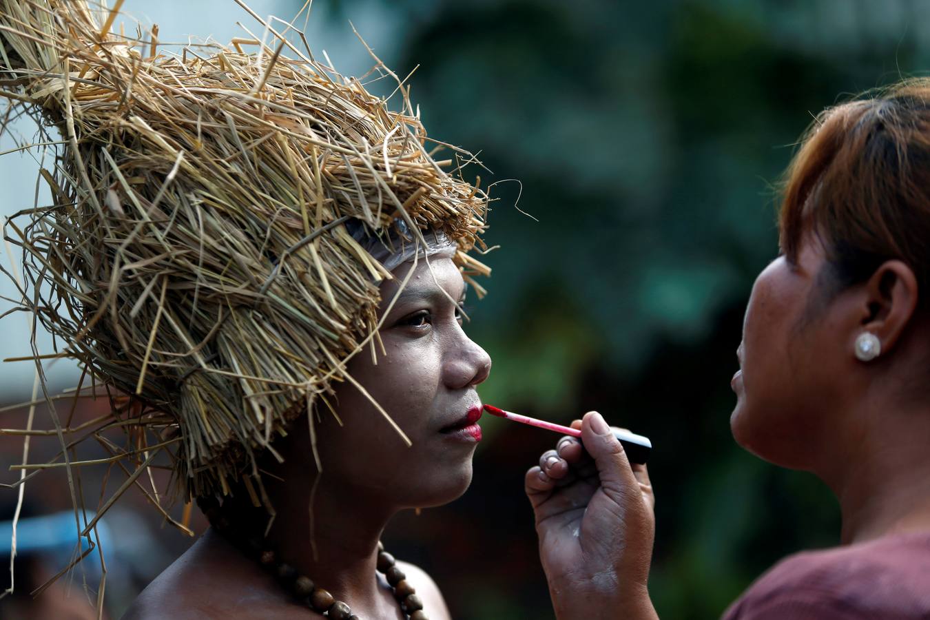 Varias personas participan en la ceremonia que honra la memoria de los espíritus del hogar de la aldea Pring Ka-Ek, este viernes en Nom Pen (Camboya). Los residentes buscan prevenir enfermedades y potenciar las cosechas a través de estos rituales milenarios.