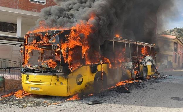 El autobús, en llamas, estacionado en Ricote.