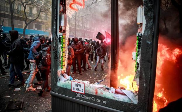 Activistas pertenecientes al Bloque Negro se enfrentan a la Policía en una calle de París.
