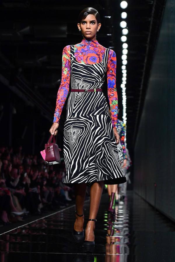 Looks total 'black' y el dúo azul-rojo en los diseños de Versace se vieron en la pasarela de Milán. La diseñadora italiana da protagonismo también al estampado floral y al print animal de cebra combinado con grandes gafas y bolsos tanto para mujeres como para hombres. 