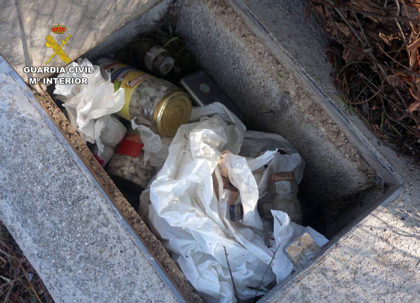 Imagen secundaria 2 - Un agente con una de las mujeres del local y la droga encontrada en una arqueta.