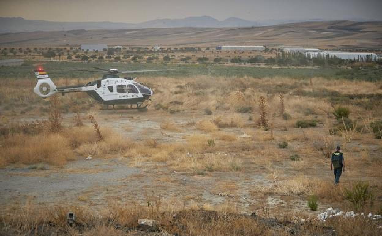 Un helicóptero de la Guardia Civil toma tierra en uno de los terrenos en los que se busca al animal.