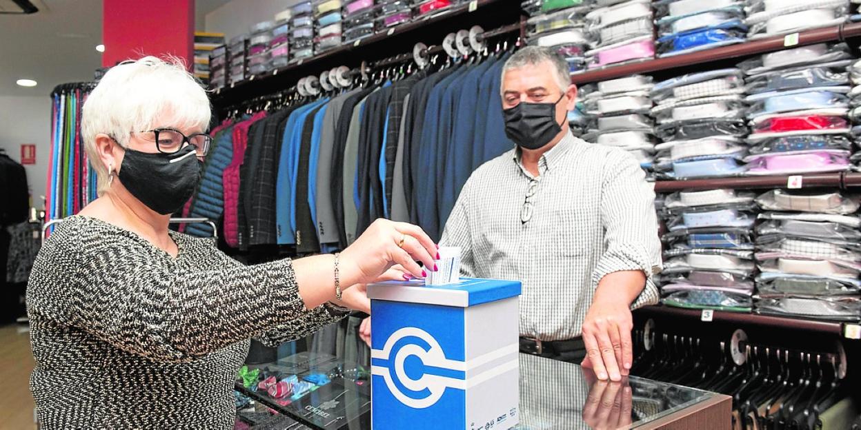 María López deposita, ayer, sus sugerencias en la urna instalada en la tienda Alemán. 