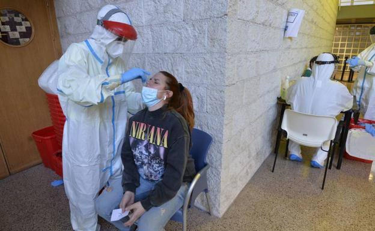 Un sanitario realiza una prueba de coronavirus a una mujer, en una imagen de archivo. 