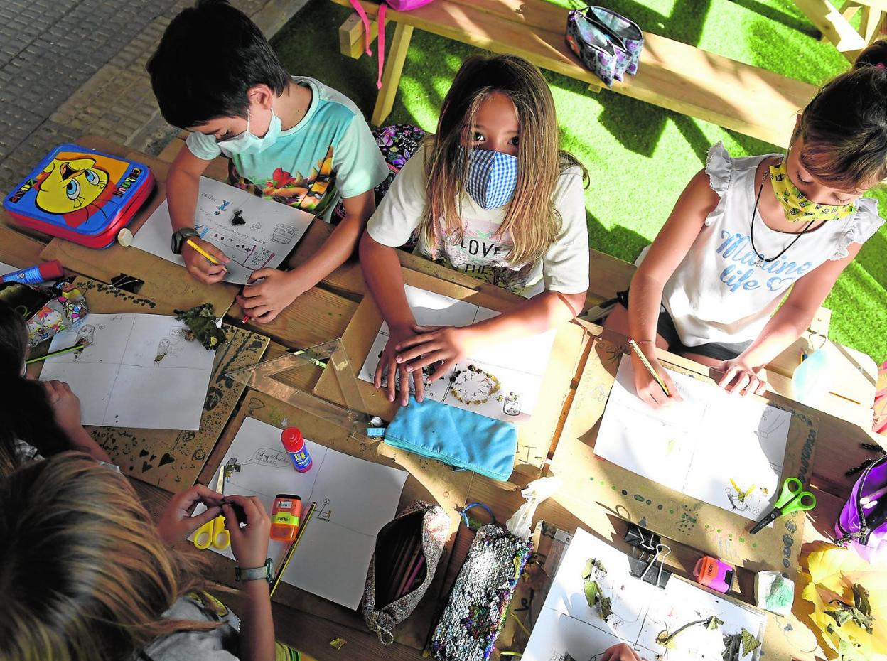 Alumnos del colegio Puente de Doñana, en la pedanía murciana de La Albatalía, ayer en clase en el patio del centro. 