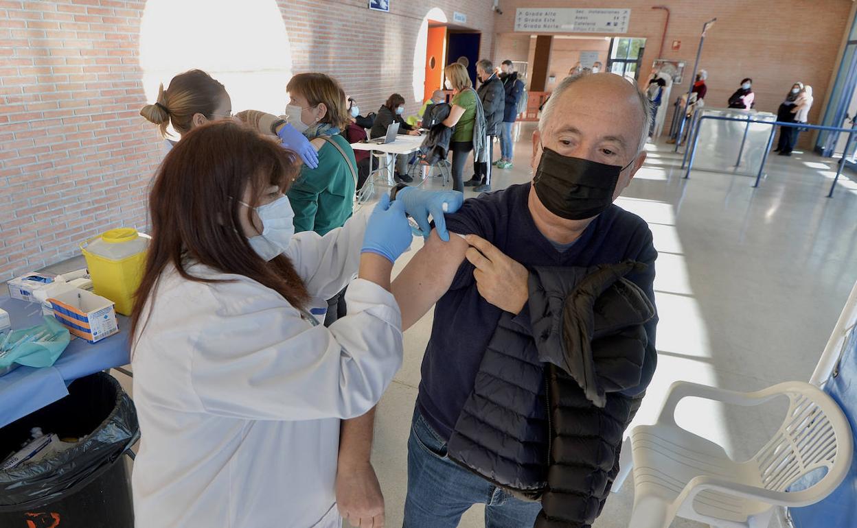 Una sanitaria vacuna a un hombre en Murcia, en una imagen de archivo.