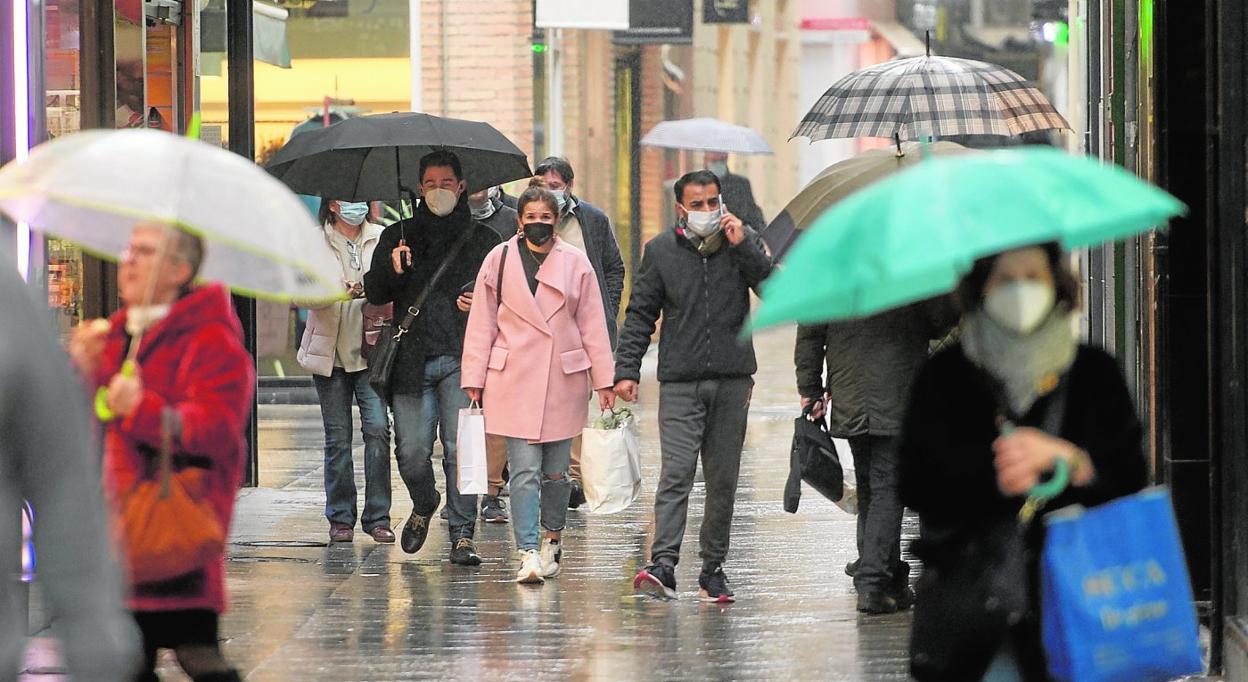 Varios ciudadanos pasean por la calle Platería tras realizar sus compras; la asociación que aglutina a los comerciantes de esta calle está al borde de la desaparición por quiebra. 
