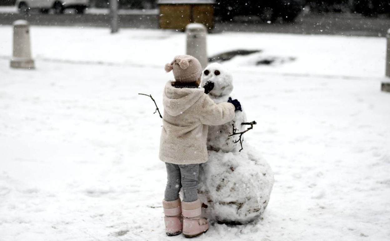 Imagen de un niño haciendo un muñeco de nieve.