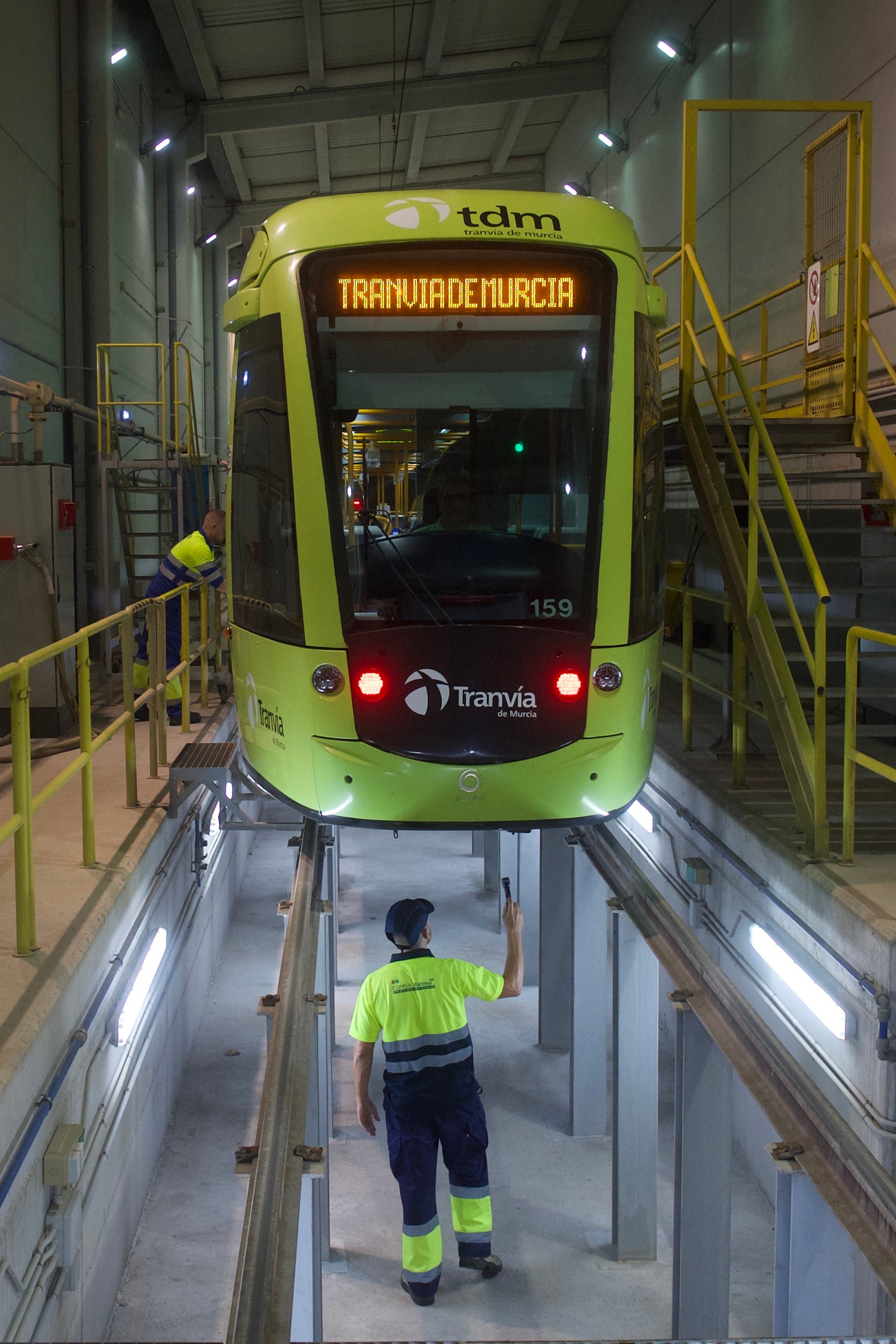 Operarios de Tranvía de Murcia revisan dos vehículos en las instalaciones de La Ladera, uno de ellos, en el foso.