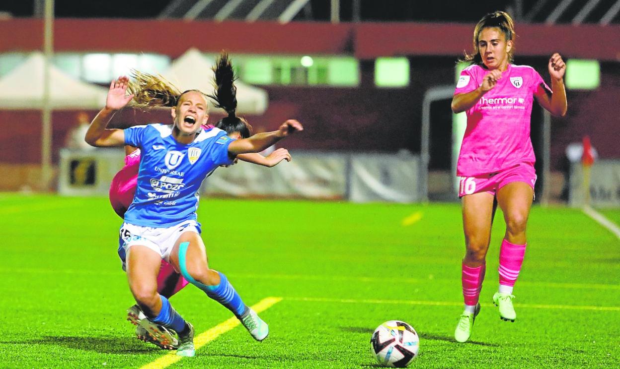 Raquel Morcillo, delantera del Alhama CF ElPozo, es derribada por una rival, anoche en el Complejo Guadalentín. 