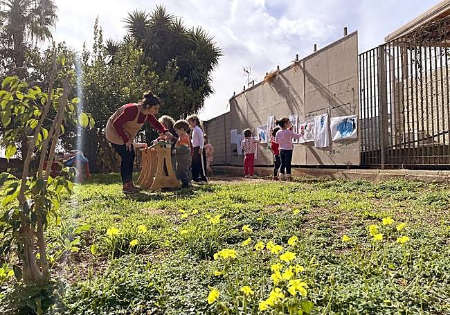 Niños participando en la escuela, con el arte como vía de aprendizaje.