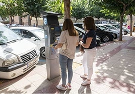 Dos mujeres sacan el tique de aparcamiento en la calle Nuestra Señora de los Buenos Libros.