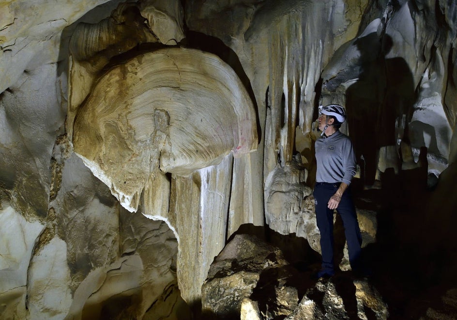 Juan, uno de los responsables de la gestión turística de la cueva, junto a la enorme y más conocida oreja del recorrido.