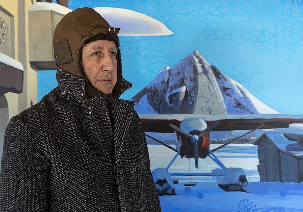 Ángel Mateo Charris, en su estudio y caracterizado de aviador, delante del óleo pintado para el cartel del festival La Mar de Músicas 2023, inspirado en sus viajes a Canadá.