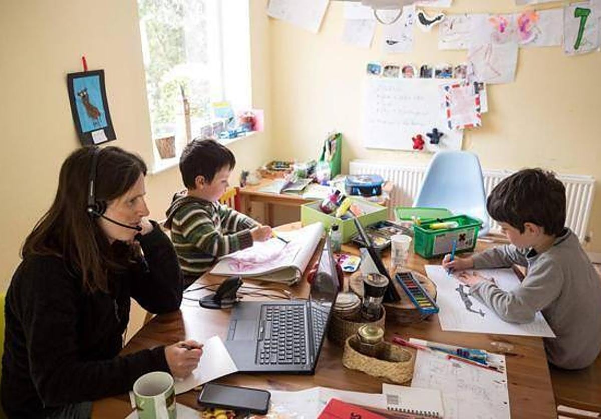 Una mujer trabaja desde su casa para atender a sus hijos en una imagen de archivo.