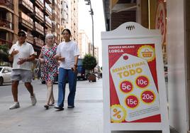 Comercios de la avenida Juan Carlos I muestran carteles con motivo de las rebajas.