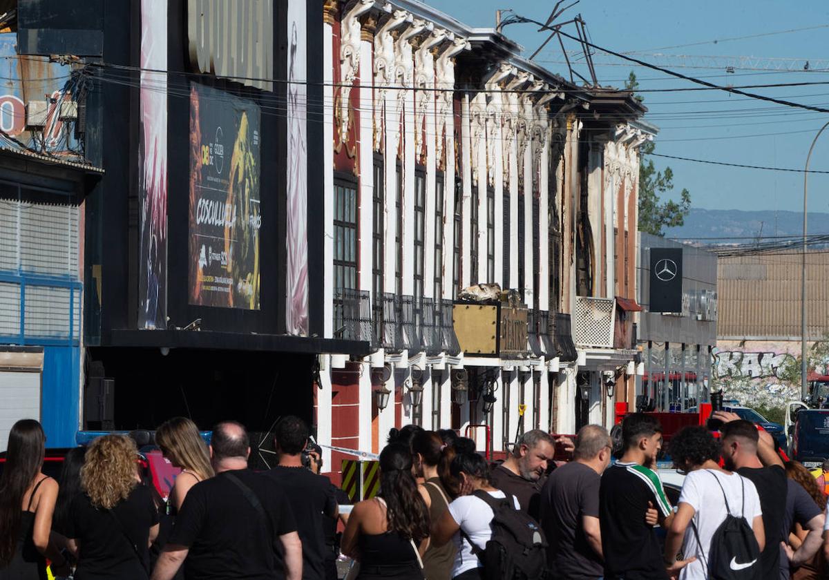 Vecinos y clientes observan las fachadas de las discotecas Teatre y Fonda Milagros, en la zona de Atalayas, afectadas por el fuego.