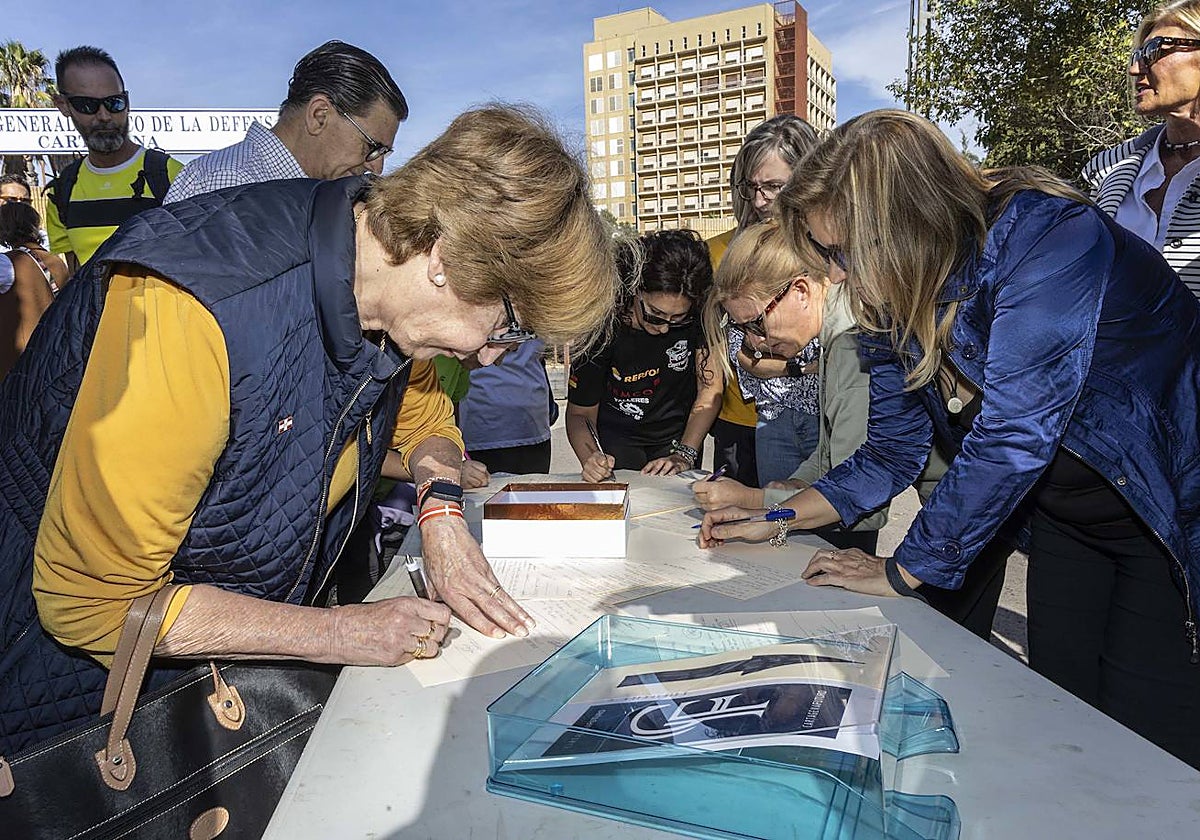 Asistentes a la concentración firman contra el uso del Naval como albergue de inmigrantes.