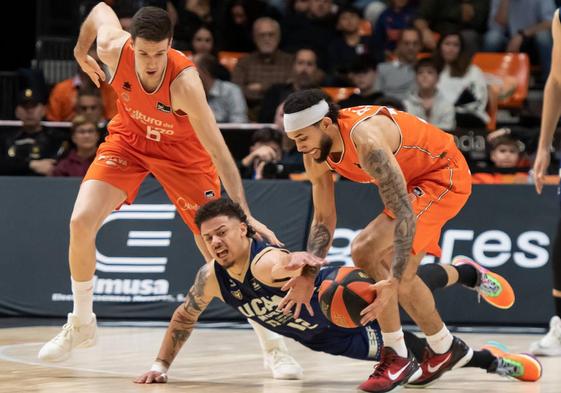 Jonah Radebaugh lucha por un balón ante dos jugadores de Valencia Basket.