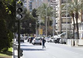 Un peatón cruza por medio de la Alameda, cerca del nuevo semáforo sin conexión.