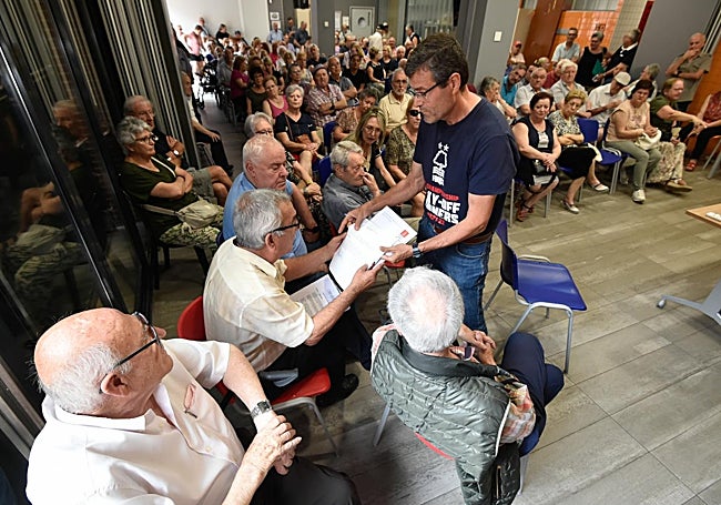 El funcionario de la Concejalía de Mayores muestra al presidente de la Asociación las firmas que se han registrado en el Ayuntamiento pidiendo la convocatoria de una asamblea.