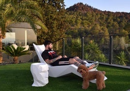 Joaquín Ganga, en una de las tumbonas de su impresionante casa, junto a Sophie, su perrita.