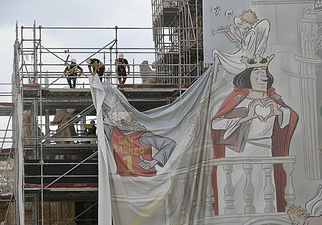 Detalle de los operarios trabajando este lunes en la retirada de la lona.