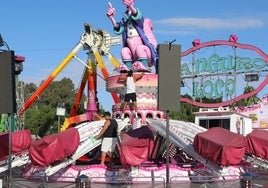 Operarios ultiman el montaje de una de las atracciones en el Huerto de la Rueda.