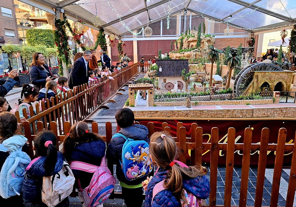 El alcalde, Joaquín Buendía, inaugura el belén ante un grupo de escolares que acudieron ayer al acto.