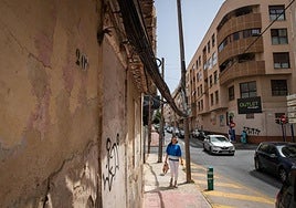 Una mujer camino por el cruce entre las calles Apolo y Diego Ramírez, con el cableado a escasos metros sobre su cabeza.