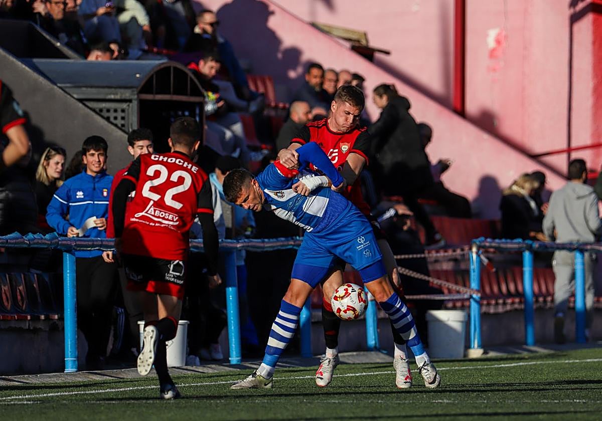 Edu Luna, del Cieza, forcejea con Andrés Carrasco, del Lorca, en el choque de ayer.